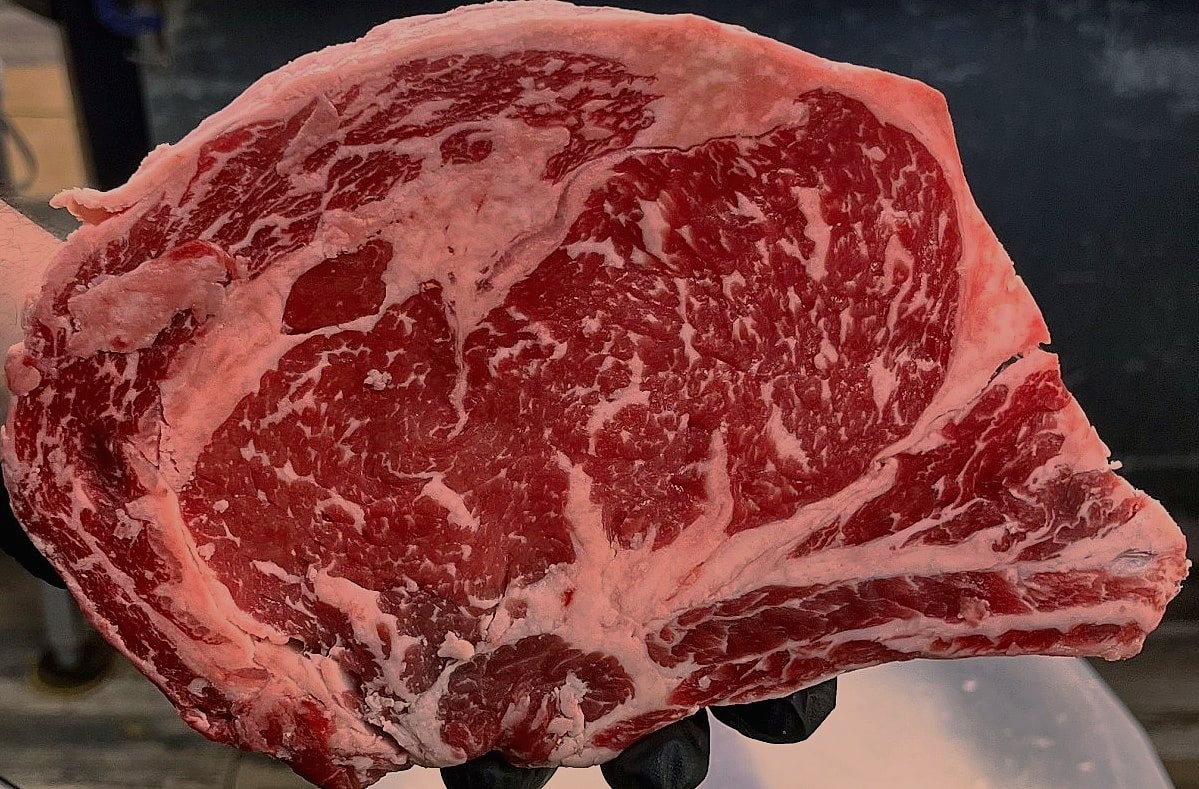 Tomahawk rib steak held at Kostas
