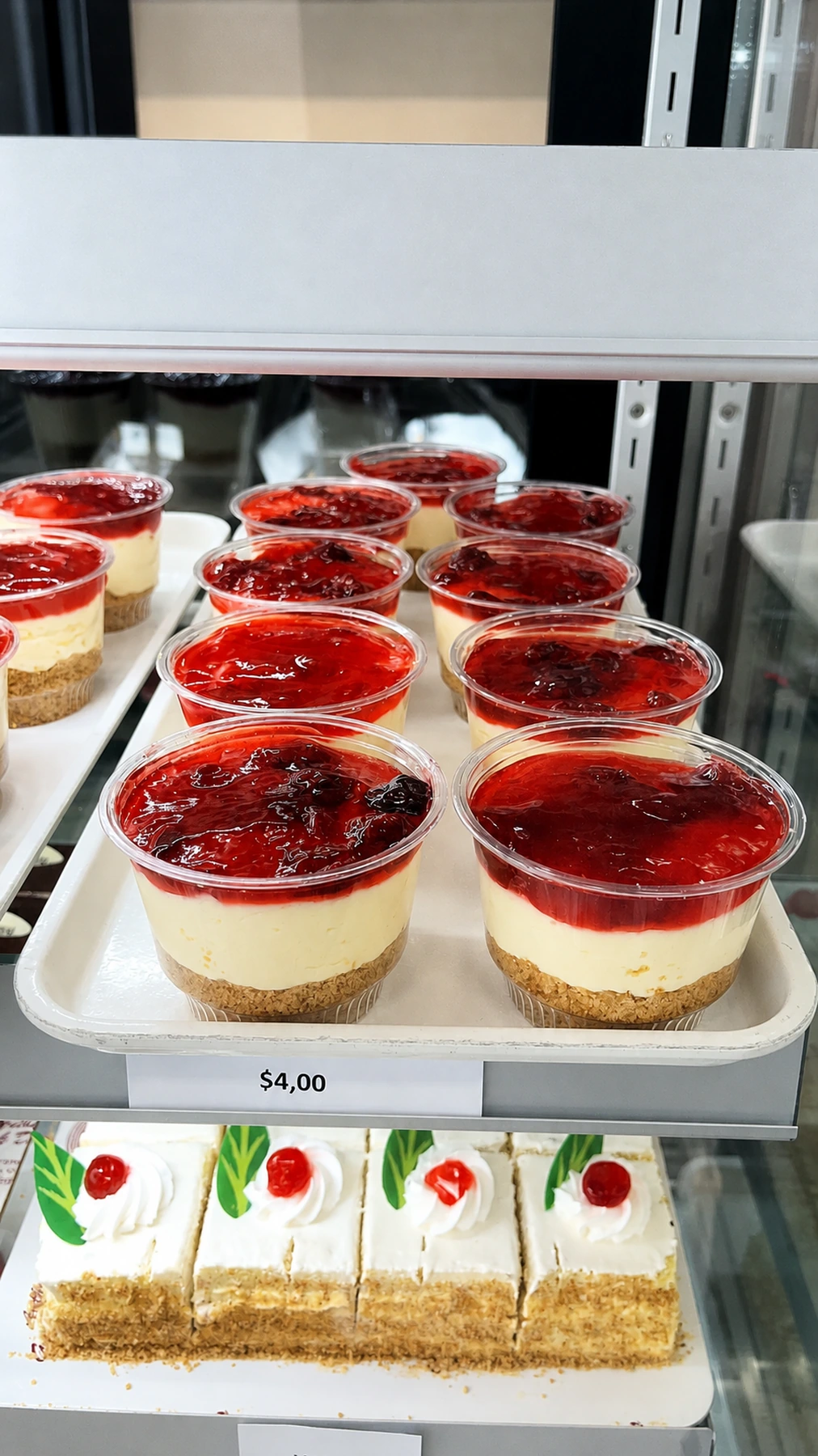 Individual strawberry dessert cups in the bakery case