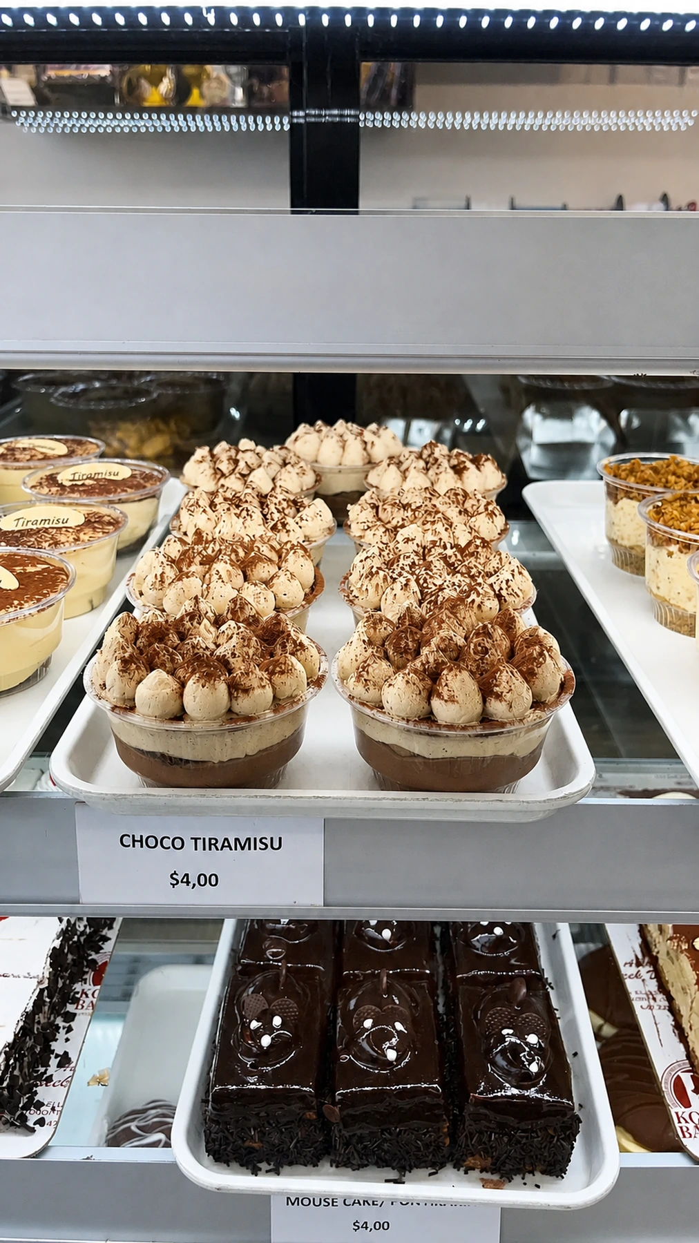 Chocolate tiramisu cups topped with cream