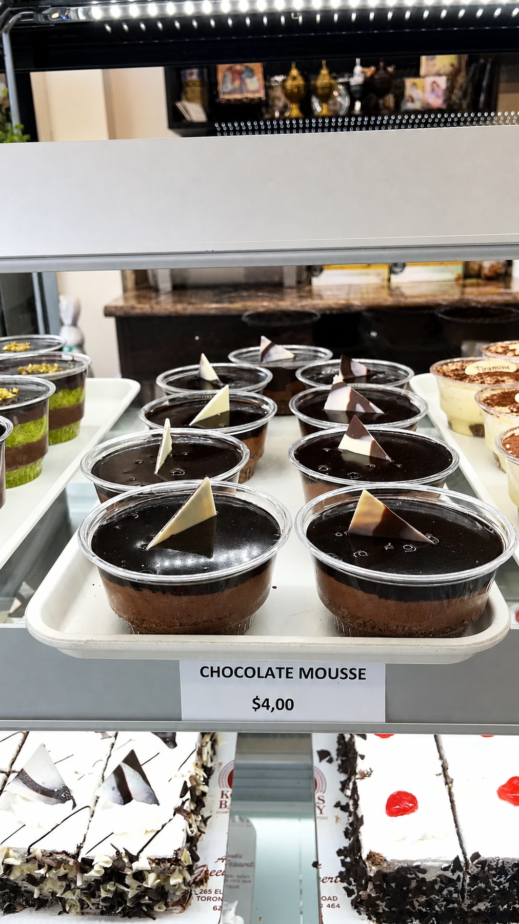 Individual chocolate mousse cups in the bakery case