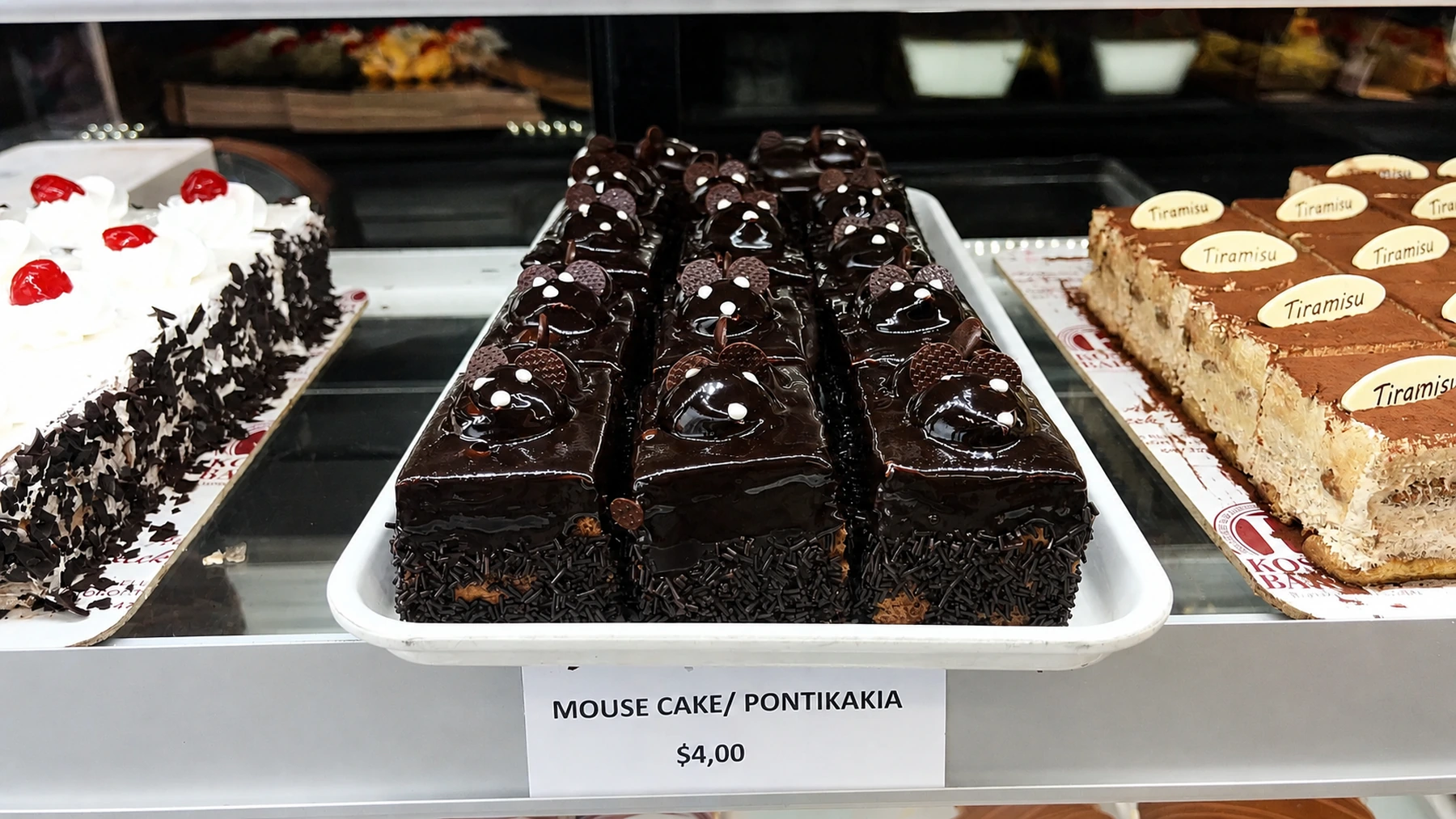 Chocolate mousse cakes arranged in the bakery display