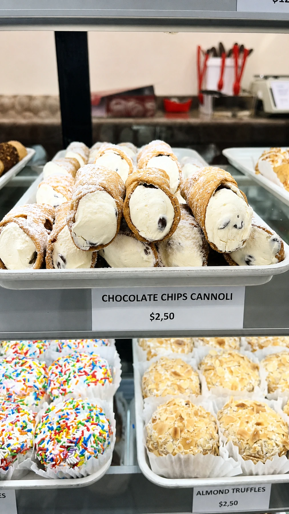 Chocolate chip cannoli arranged in the display case