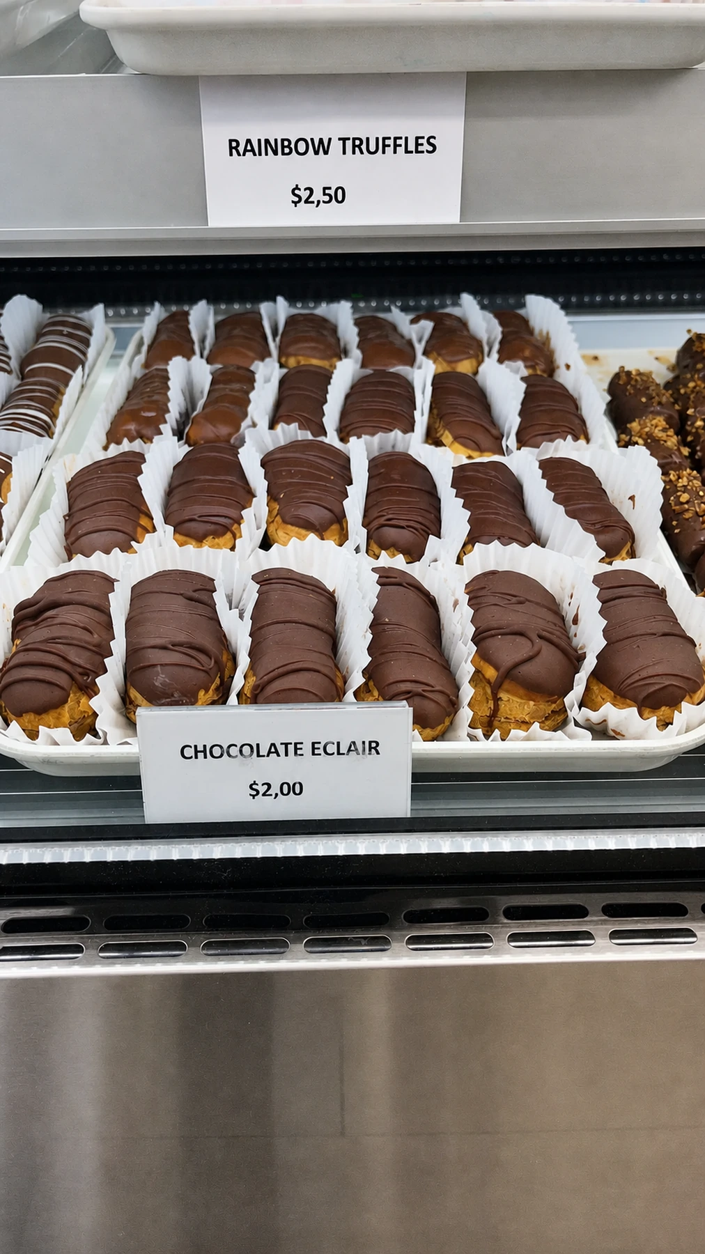 Rows of vanilla eclairs in the display case