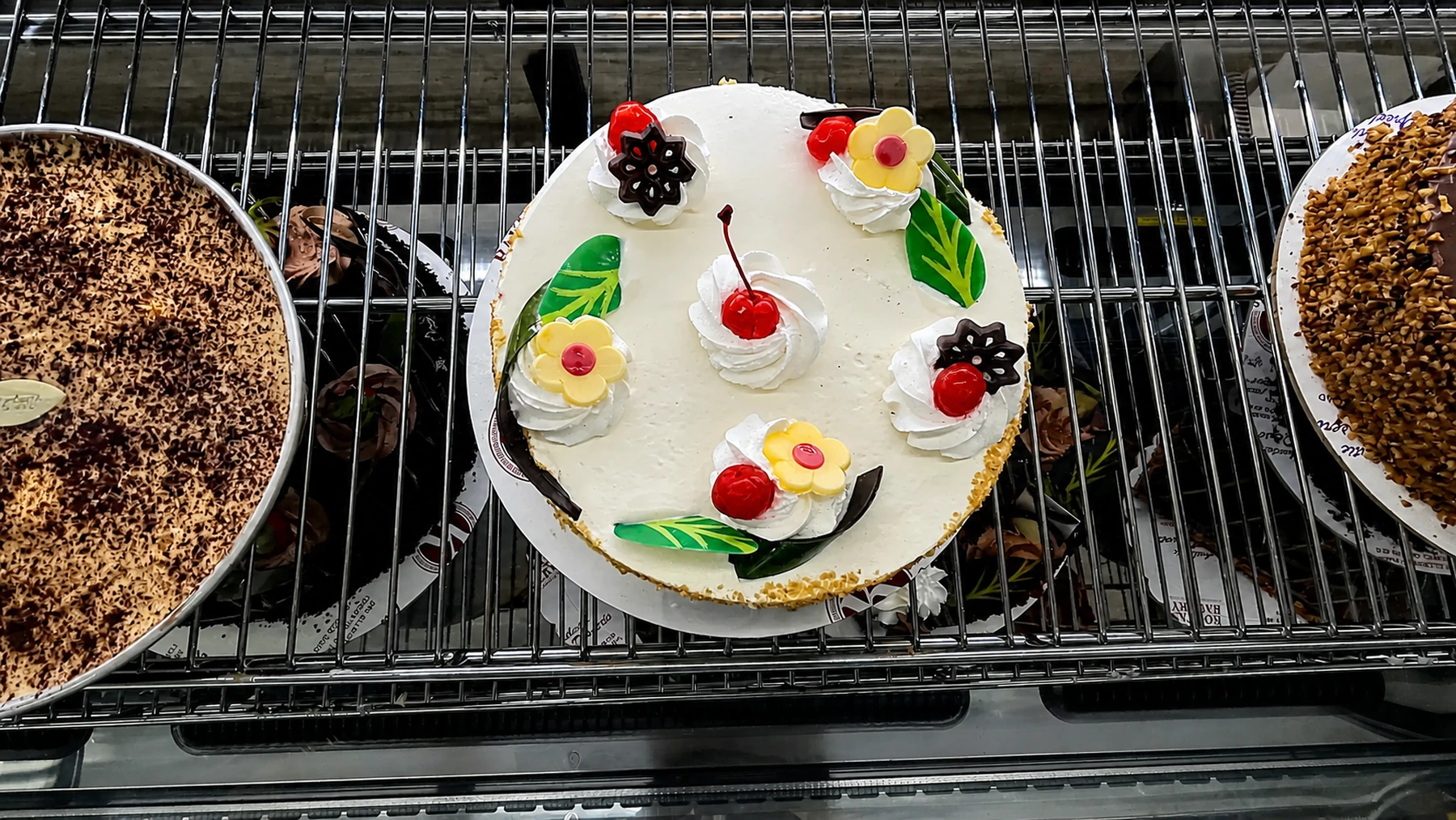 A decorated celebration cake in the chilled bakery case