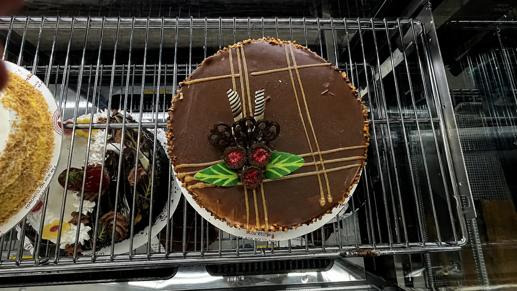 A round chocolate cake decorated with chocolate lines