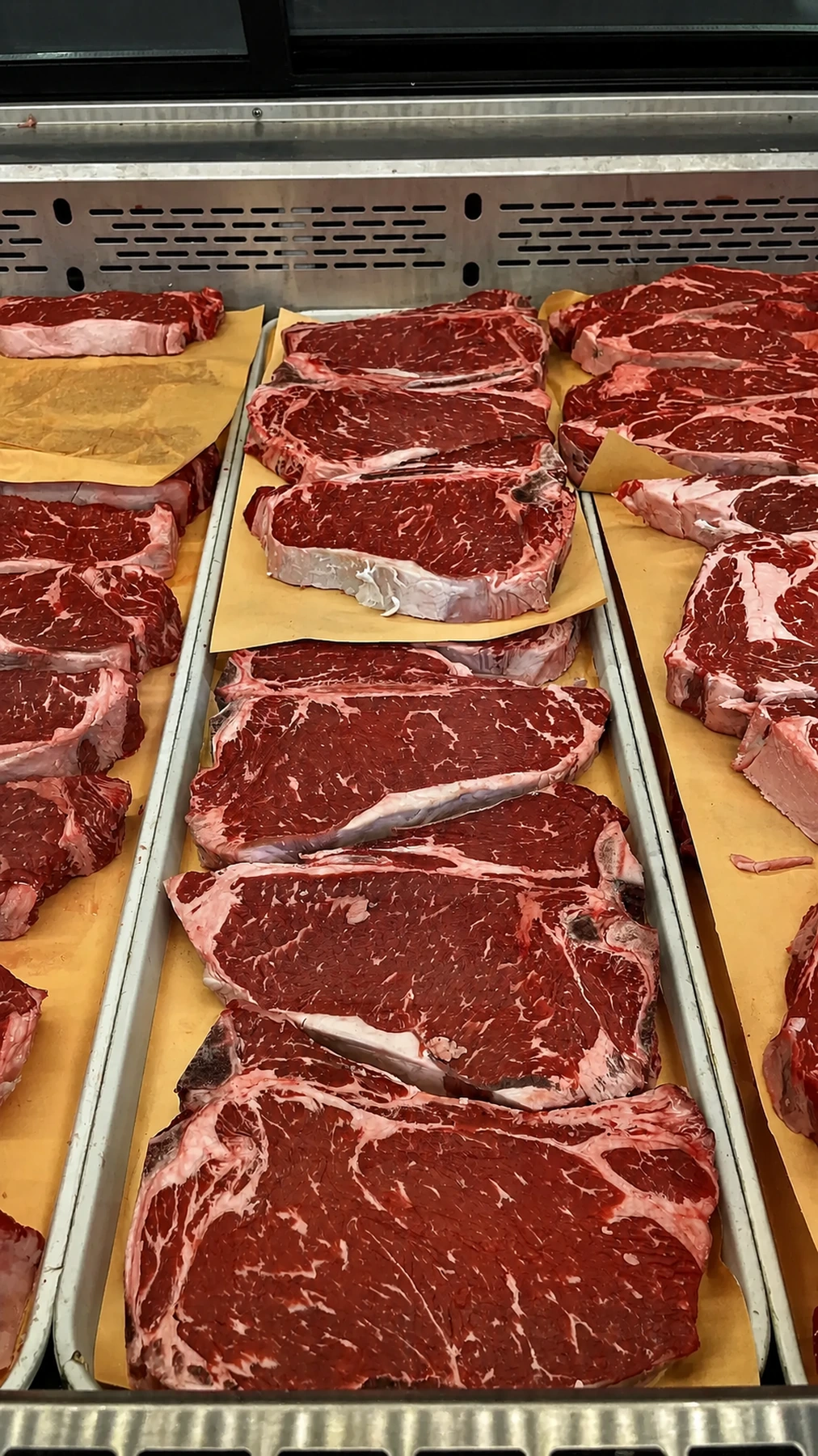 Fresh steak cuts arranged in the butcher case