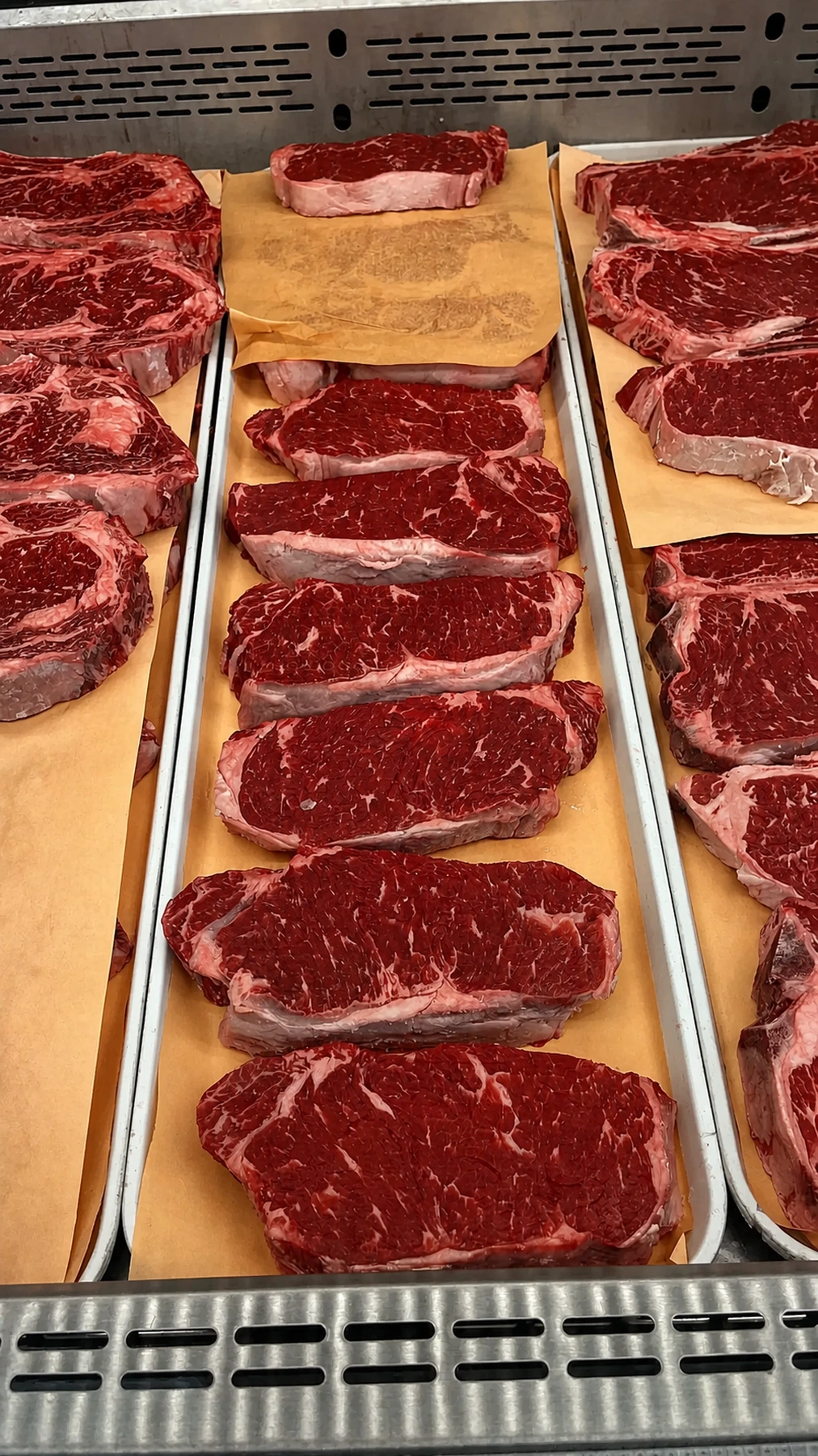Fresh lean steak cuts arranged at the butcher counter